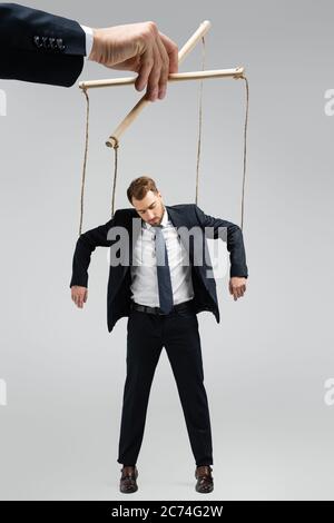 Puppeteer Holds The Puppet Business Man On The Ropes Stock Photo, Picture  and Royalty Free Image. Image 28107184.