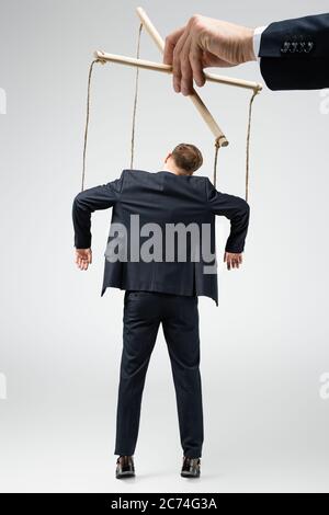 smiling female puppeteer holding male marionette isolated on grey Stock  Photo - Alamy