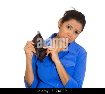 Closeup portrait of an upset, sad, unhappy woman standing showing empty wallet, isolated against white background Stock Photo