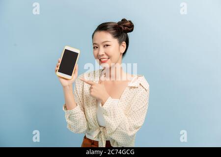 Photo of funny pretty lady hold new model smart phone direct finger touch screen advising good nice offer Stock Photo