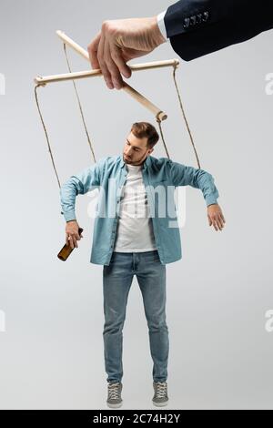 smiling female puppeteer holding male marionette isolated on grey Stock  Photo - Alamy