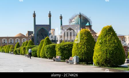 Isfahan, Iran - May 2019: Unidentified Iranian man walking in Isfahan Naqsh-e Jahan Square also called Imam Square Stock Photo
