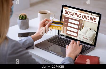 Businesswoman making online reservation, using laptop at workplace Stock Photo