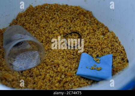 fish food in a plastic bucket Stock Photo