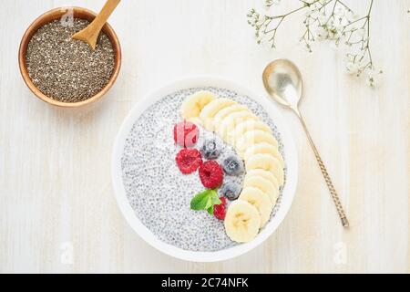 Chia pudding in bowl with fresh berries raspberries, blueberries Stock Photo