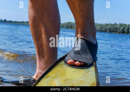 legs in fins on the river near the water Stock Photo