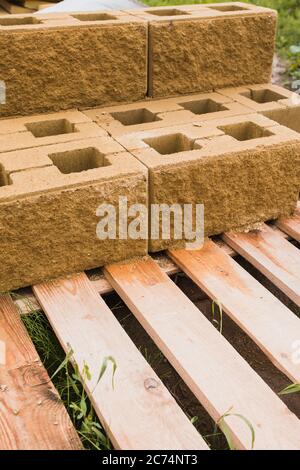Concrete blocks on a wooden pallet at a construction site - building a house Stock Photo