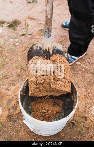 Mortar mixing for masonry at a construction site - construction of a brick block house - cement-sand mixture Stock Photo