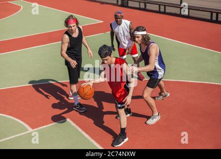 Multiracial basketballers participating in outdoor championship at court, above view Stock Photo