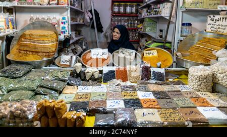Isfahan, Iran - May 2019: Iraqnian woman selling various herbs and spices in Grand bazaar of Isfahan, historical market Stock Photo