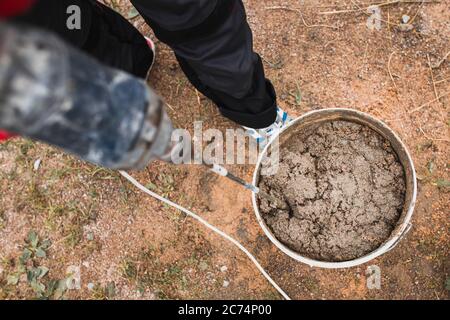 Mortar mixing for masonry at a construction site - construction of a brick block house - cement-sand mixture Stock Photo