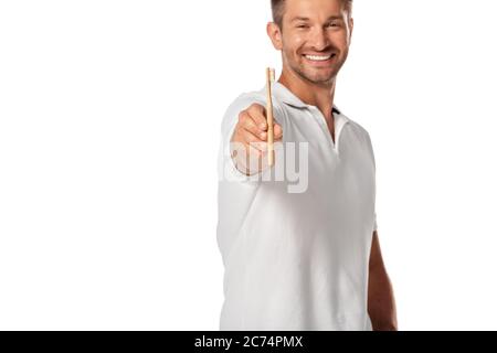 selective focus of cheerful man holding toothbrush isolated on white Stock Photo