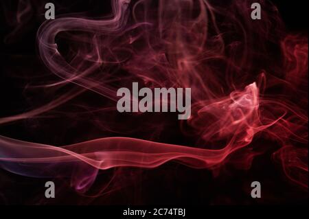 Abstract mystery  smoke swirls red color on black background. Elegant colorful curves wallpaper Stock Photo