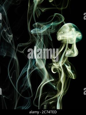 Abstract smoke swirls wave green color on black background. Elegant colorful curves wallpaper Stock Photo