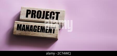 Projects Management on wooden blocks on pink. Business concept Stock Photo
