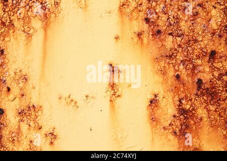 Rust covered weathered iron metal texture background with yellow peeling blistering paint Stock Photo