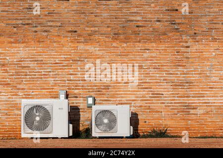 Air cooled condensers isolated on red brick wall. Stock Photo