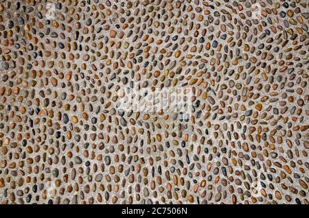 Background from multi-colored pebbles in cement (concrete) Stock Photo