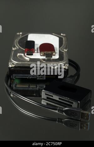 Universal card reader and hard drive isolated on black background Stock Photo