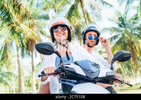 Two men with helmet riding a scooter motorbike and looking at camera Stock  Photo - Alamy