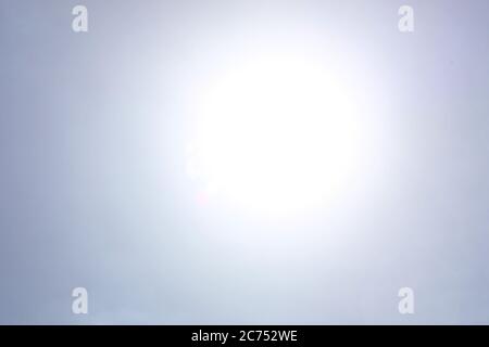 Shining sun at clear blue sky background Stock Photo