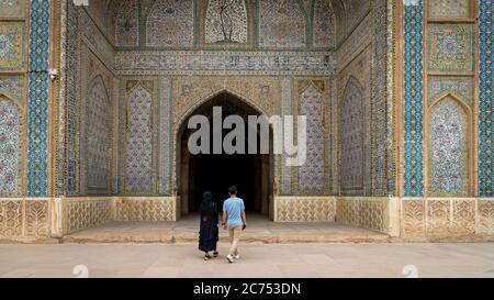 Shiraz, Iran - May 2019: Unidentified couple walking towards the prayer hall of Vakil Mosque, Shabestan. Vakil means regent, title of Karim Khan, foun Stock Photo