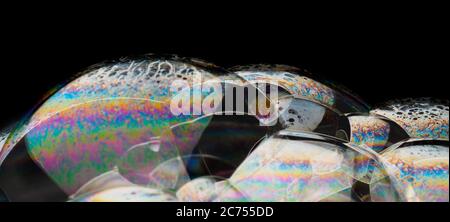 Coloful soap bubbles on black background isolated. Macro shot for design Stock Photo