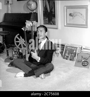Comedian and television game show host Bob Monkhouse at home looking through his collection of silent movies Stock Photo