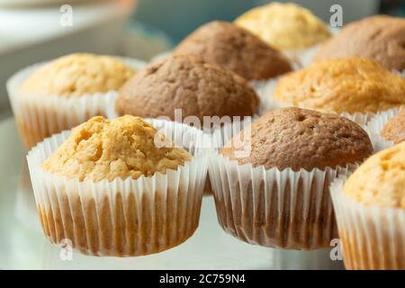 Baked muffins in white paper forms Stock Photo