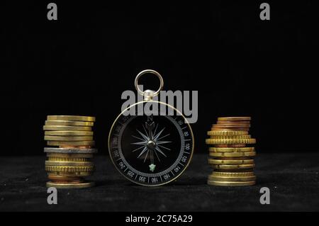 Orientation in Business Compass and Money on a Black Background Stock Photo