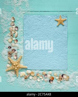 Blue crumpled sheet of paper on turquoise style. Place for text. Decor of seashells. Top view. Stock Photo