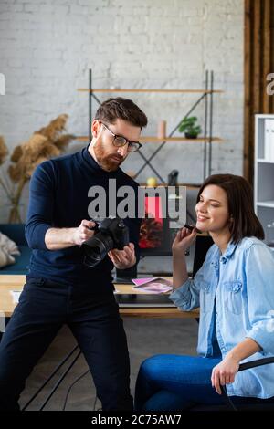 Photographer and graphic designer working in office with laptop, monitor, graphic drawing tablet and color palette. Creating team discussing ideas in Stock Photo