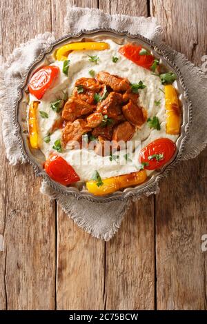 Alinazik kebab is a home-style Turkish dish which is a specialty of the Gaziantep province of Turkey closeup in the plate on the table. vertical top v Stock Photo