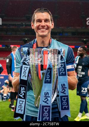 London, UK. 13th July, 2020. Matt Bloomfield of Wycombe Wanderers with the winning trophy during the Sky Bet League 1 play-off final match between Oxford United and Wycombe Wanderers played behind closed doors due to government restrictions on football during the worldwide Covid-19 pandemic, match played at Wembley Stadium, London, England on 13 July 2020. Photo by Andy Rowland. Credit: PRiME Media Images/Alamy Live News Stock Photo