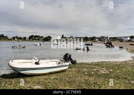 Small motor fishing boat on the beach at Mudeford Harbour Stock Photo