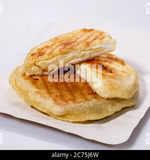 Fried potato pies. Patties with dill. Cheap recipe for homemade fried pies on a white background. Side view. Stock Photo