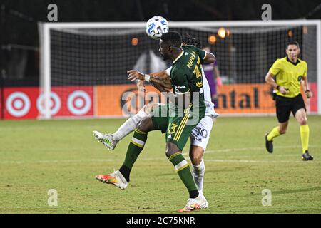 Orlando Florida USA. 13th July 2020. Portland Timbers defender Mabiala, Larrys #33 and LA Galaxy Forward Pavon, Cristian #10 Fight for the header during the MLS is Back Tournament at ESPN Wild World of Sports in Orlando Florida USA on Monday July 14, 2020.  Photo Credit:  Marty Jean-Louis Credit: Marty Jean-Louis/Alamy Live News Stock Photo