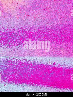 Fragment of colorful graffiti painted on a concrete wall. Bright pink or purple abstract background for design. Stock Photo
