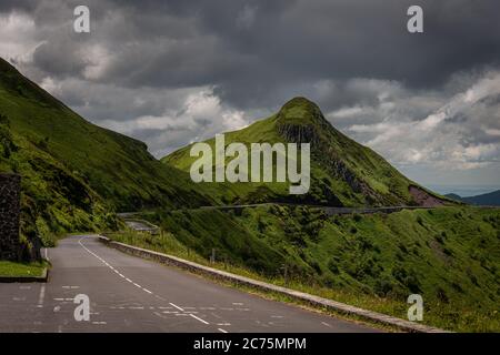 mountain road or  pass , pas de peyrol ,auvergne, cantal France , landcape , with cloudy sky ,walking ,adventure holiday. Stock Photo