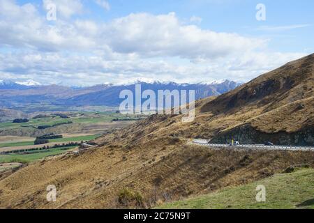 The Crown Range lies between Queenstown and Wanaka. The road over the range, known as the Crown Range Road, is the highest main road in New Zealand. Stock Photo