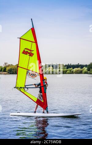 A young person learning to windsurf on one of the lakes at Cotswold Water Park. Stock Photo