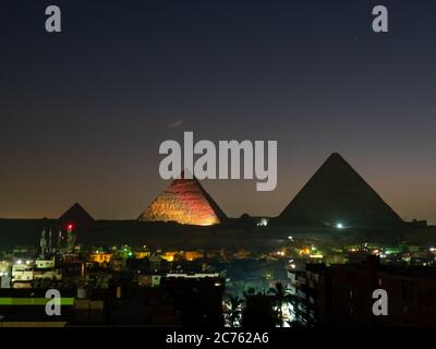 pyramids with skyline of giza at night with illustration lightshow ...