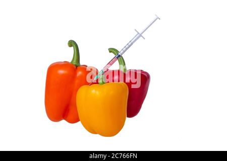 Genetically modified vegetables. GMO food concept. Syringes are stuck in vegetables with chemical additives. Injections into fruits and vegetables. Is Stock Photo