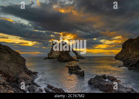 BOW FIDDLE ROCK PORTKNOCKIE MORAY COAST SCOTLAND SUMMER MORNING LATE SUNRISE WITH GOLD CLOUDS AND LIGHT ON THE ROCKS Stock Photo