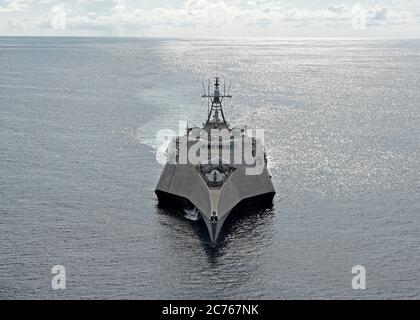 The U.S. Navy Independence-variant littoral combat ship USS Gabrielle Giffords underway during a routine presence patrol in International Waters June 16, 2020 in the South China Sea. Stock Photo