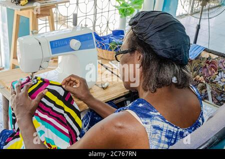 Dressmaker Stitching Colorful Garment Stock Photo
