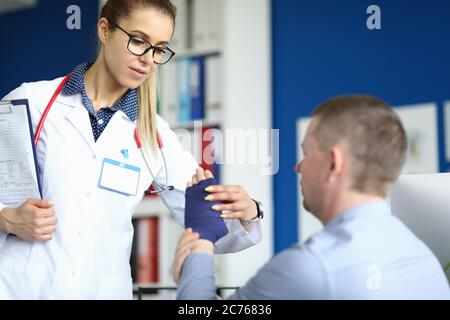 Concentrated blonde nurse with paper Stock Photo
