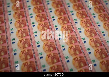 10 euro bills printed in illegal money production conveyor. Collage of many fake bills. Concept of counterfeitters mass work Stock Photo