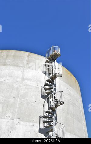 Spiral stairs on the side of a water tank in San Francisco for drinking water made of concrete and is round on Buena Vista island in the bay Stock Photo