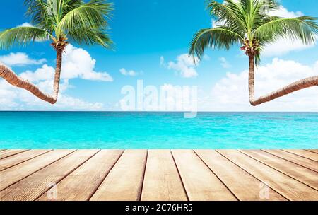 Coconut palm trees against blue sky and beautiful beach in Punta Cana, Dominican Republic. Vacation holidays background wallpaper. View of nice tropic Stock Photo